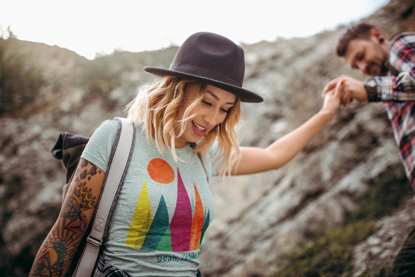 Woman with hat wearing Yeah I'd hike that mountain shirt while hiking