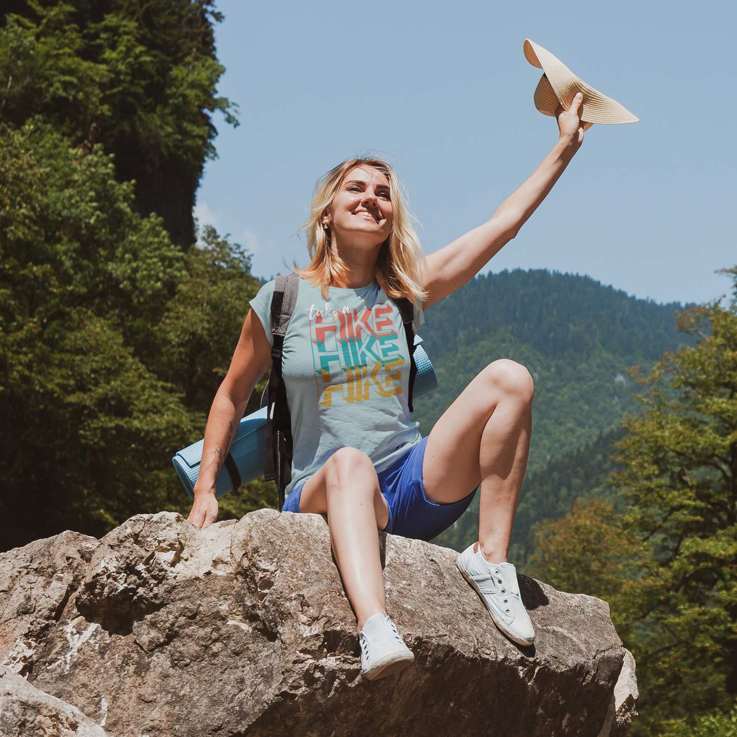 Woman wearing a take a hike short sleeve dusty heather blue tee shirt